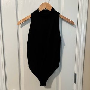 Black turtleneck bodysuit. Size small. Never worn.